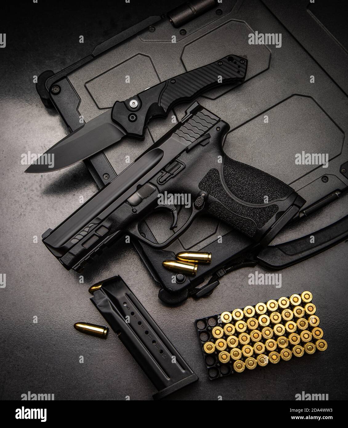 A pistol, cartridges for it and a folding knife on a dark background.  Self-defense and survival kit. Compact edged weapons and firearms Stock  Photo - Alamy