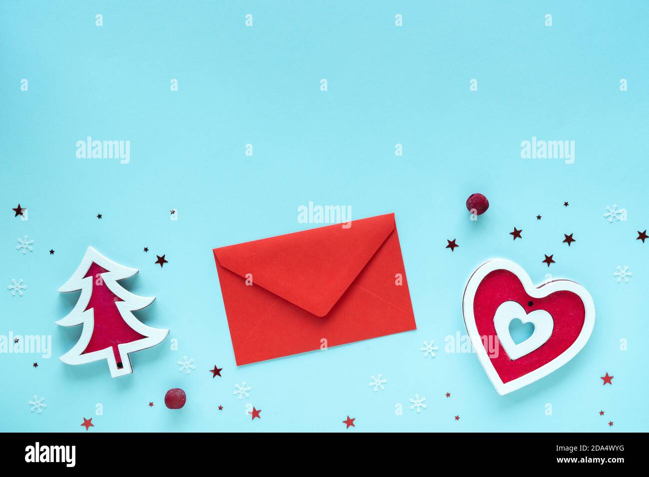 Christmas letter with red and white decorations on pastel blue surface, top view, copy space. Christmas composition. Merry Christmas and Happy Stock Photo