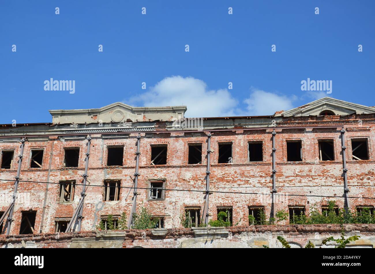 Brick facade of an abandoned old building with windows Stock Photo - Alamy