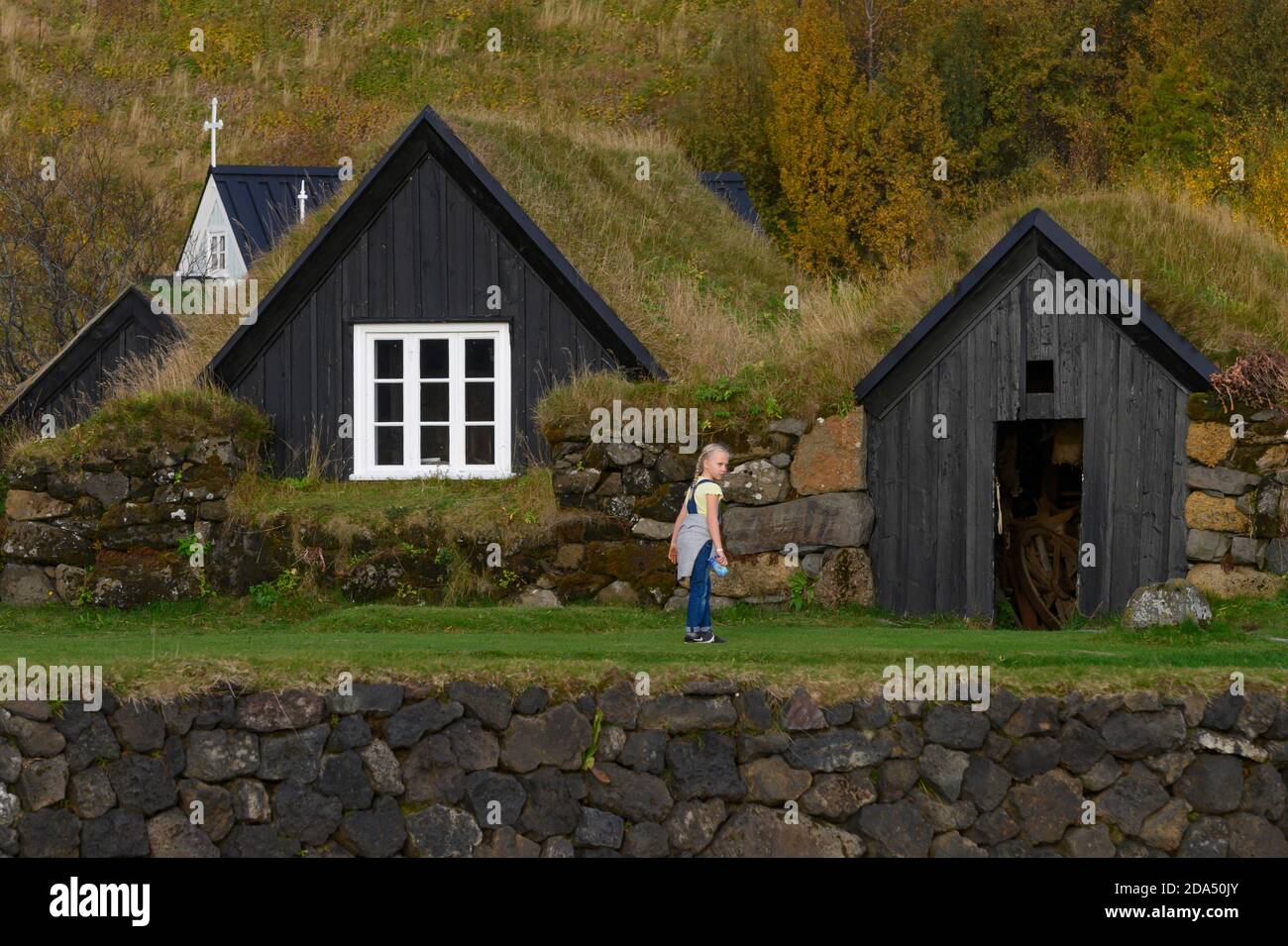 Girl standing in front of Skogar Museum, Rangarthing Eystra, Southern Region, Iceland Stock Photo