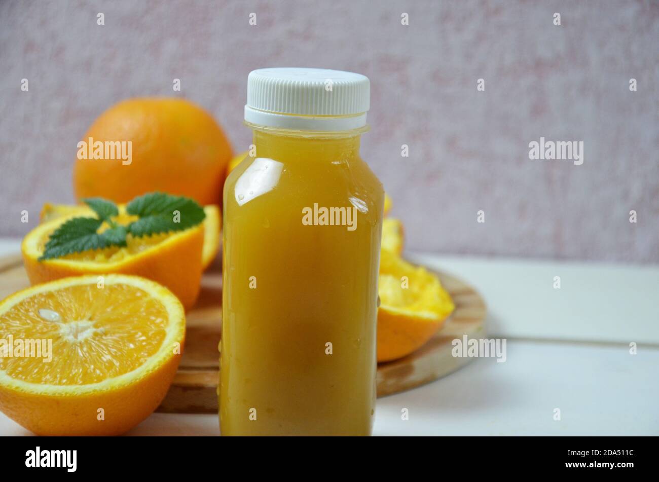 Bottle of orange juice shot. orange organic freshly squeezed juice in a