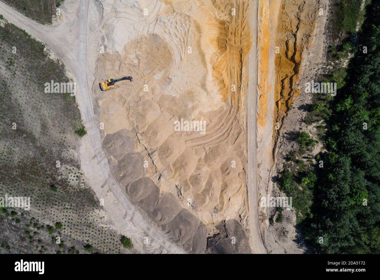Sand pit quarry with big excavator, digger. Heavy machinery industry in Europe, Poland. Ecology and environmental. Aerial drone photo View Stock Photo