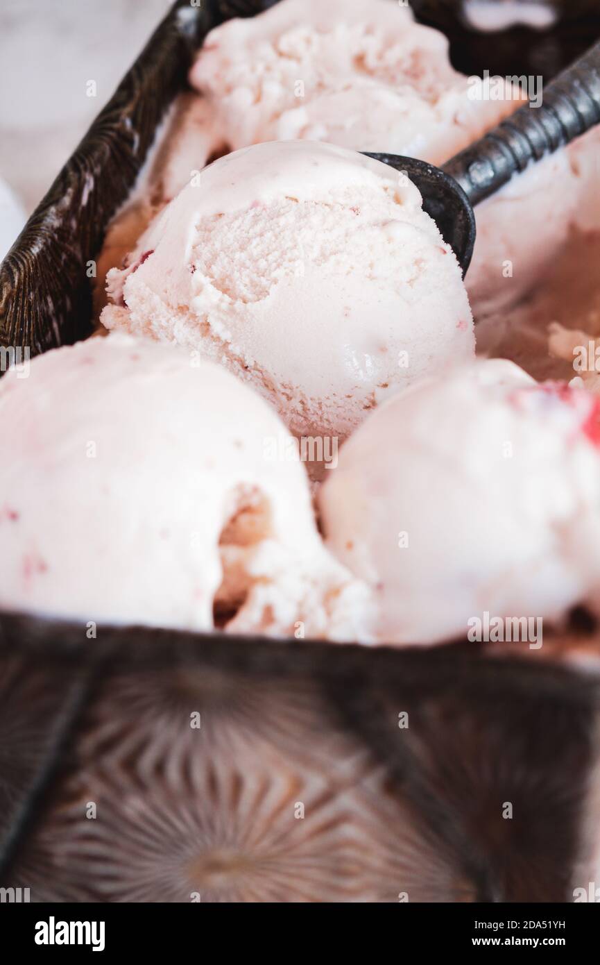 https://c8.alamy.com/comp/2DA51YH/vintage-loaf-pan-with-homemade-strawberry-ice-cream-selective-focus-on-scoop-in-center-2DA51YH.jpg