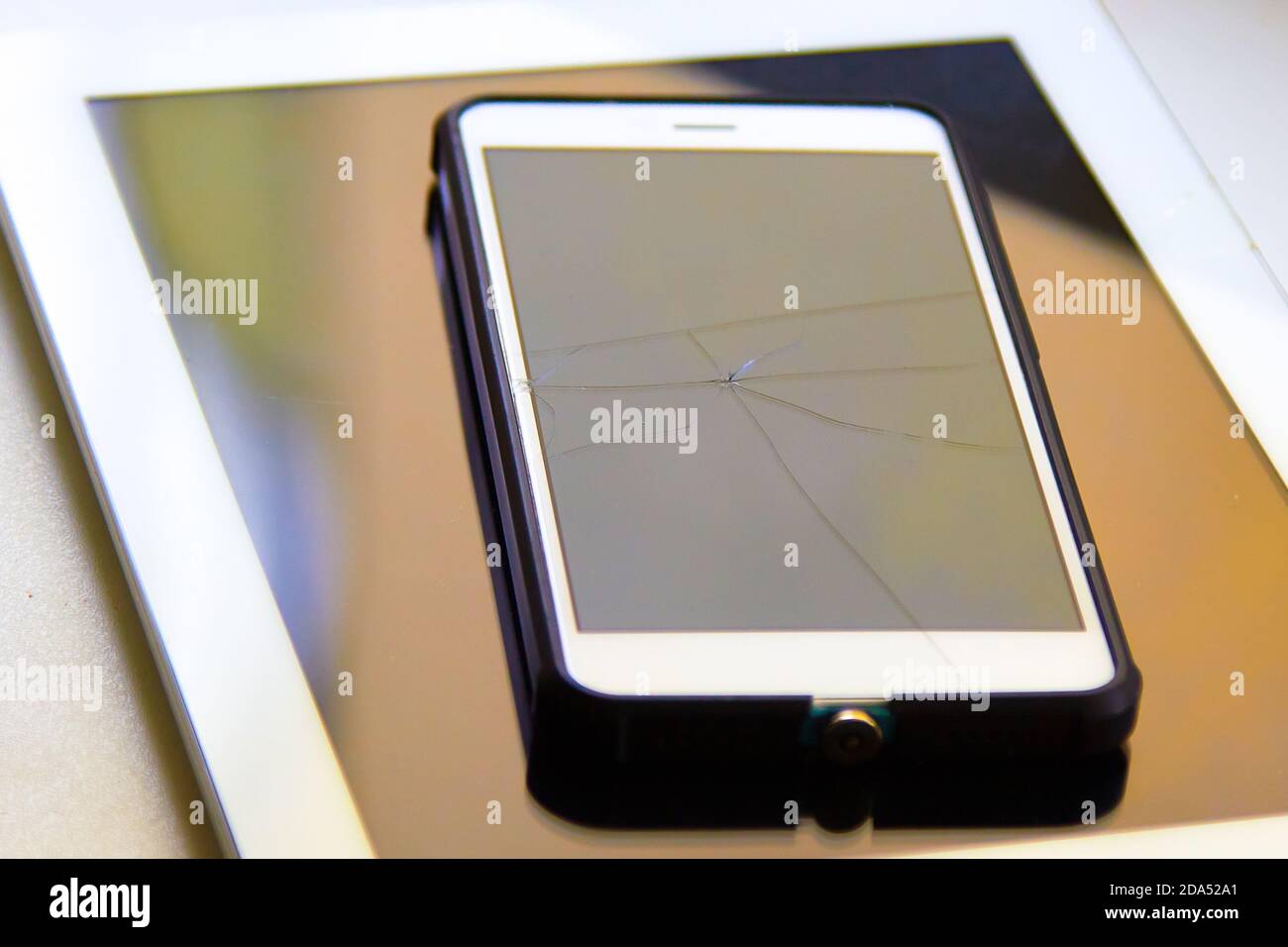 Colored highlights of a broken mobile phone screen in the reflection of  daylight Stock Photo - Alamy