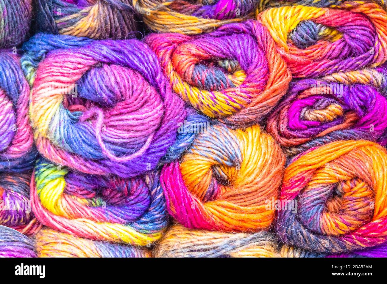 bobbins of multi-colored wool yarn for knitting Stock Photo