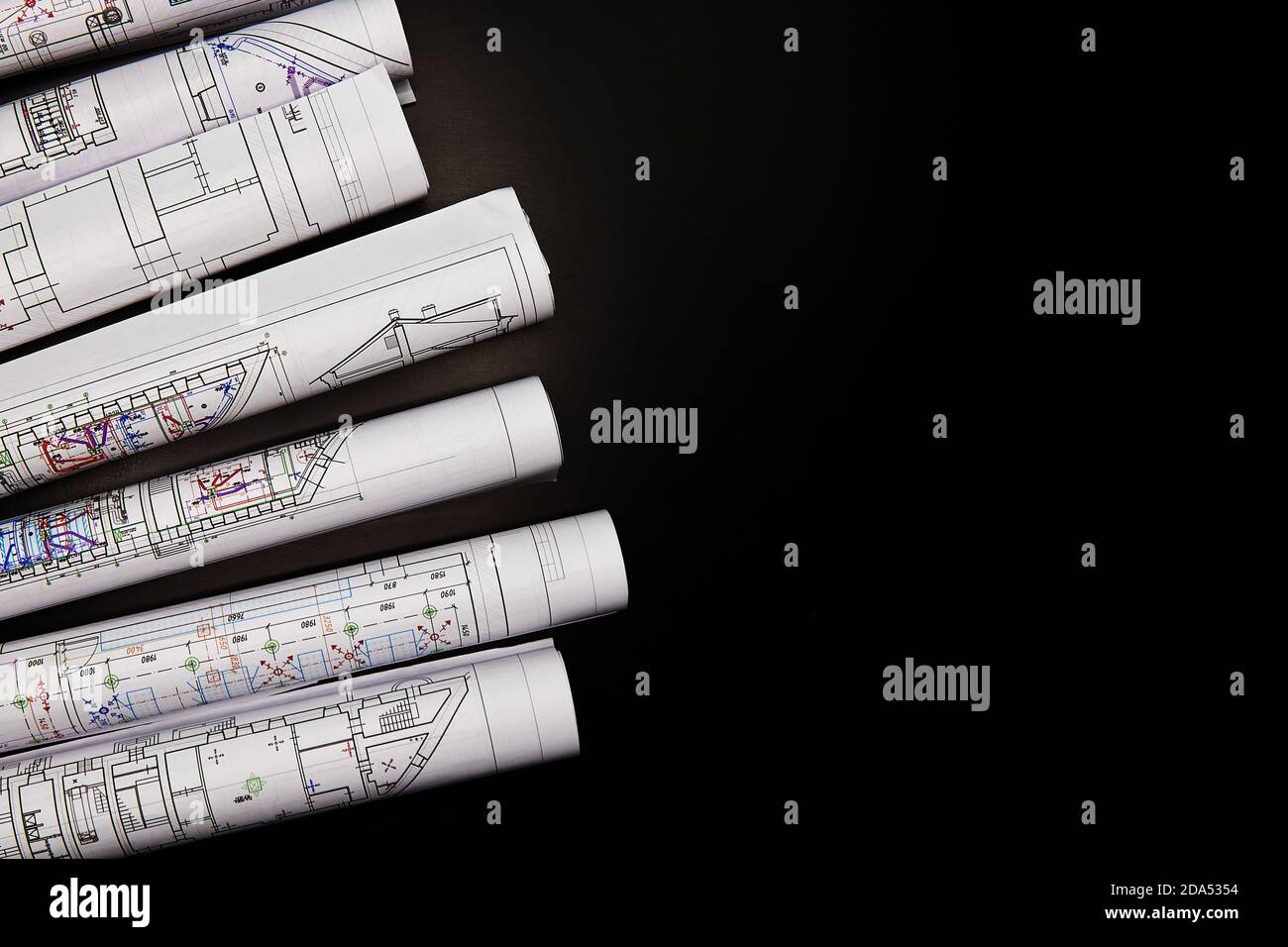 Architectural project, drawings on a dark background. Rolls of project drawings Stock Photo