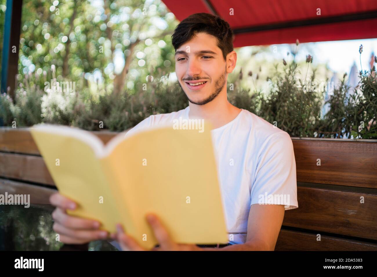 Man enjoying free time and reading a book Stock Photo - Alamy