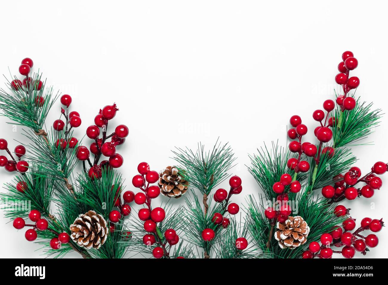 Christmas background with green fir tree branches, pine cones and red ...