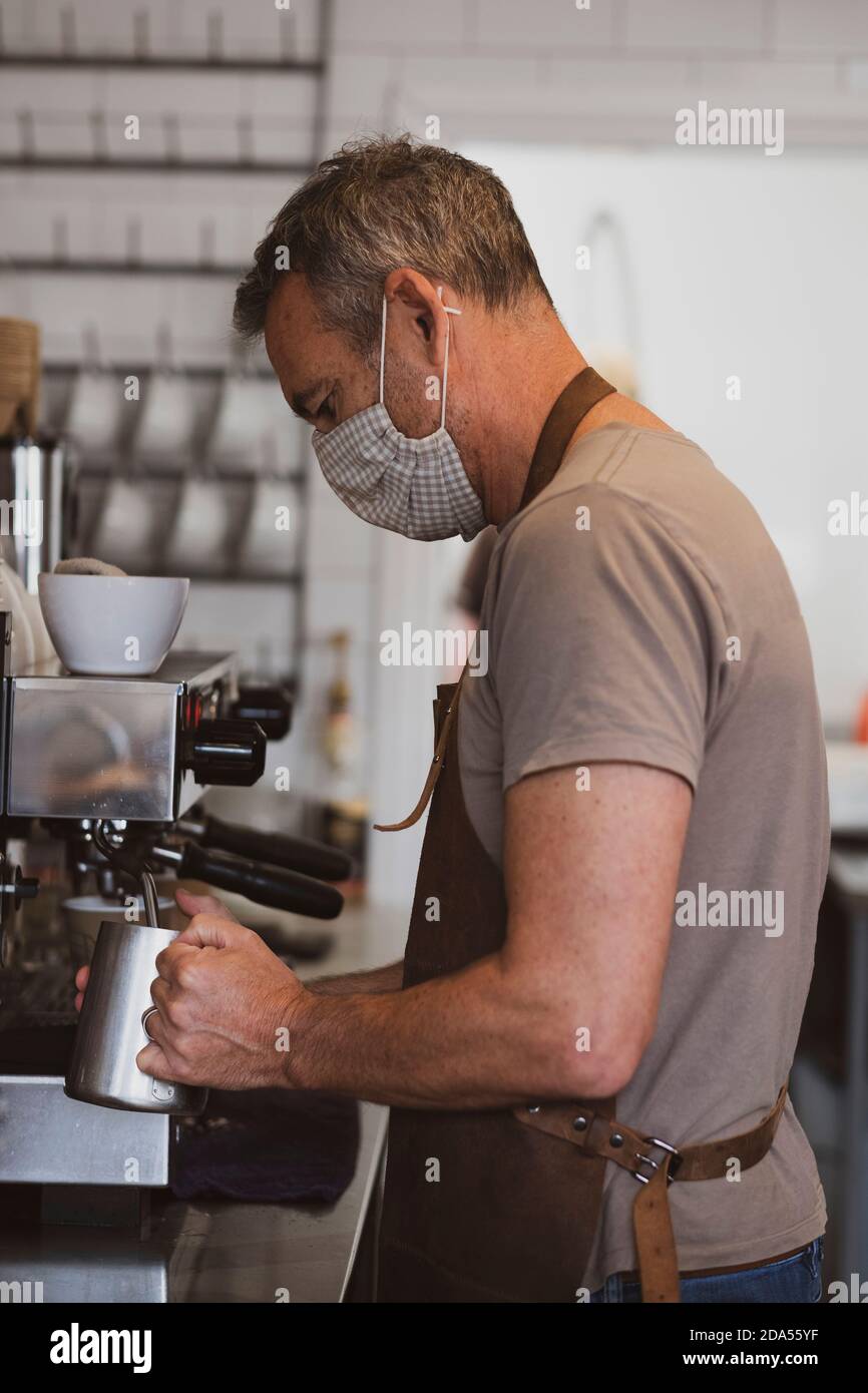 Male barista wearing brown hi-res stock photography and images - Alamy