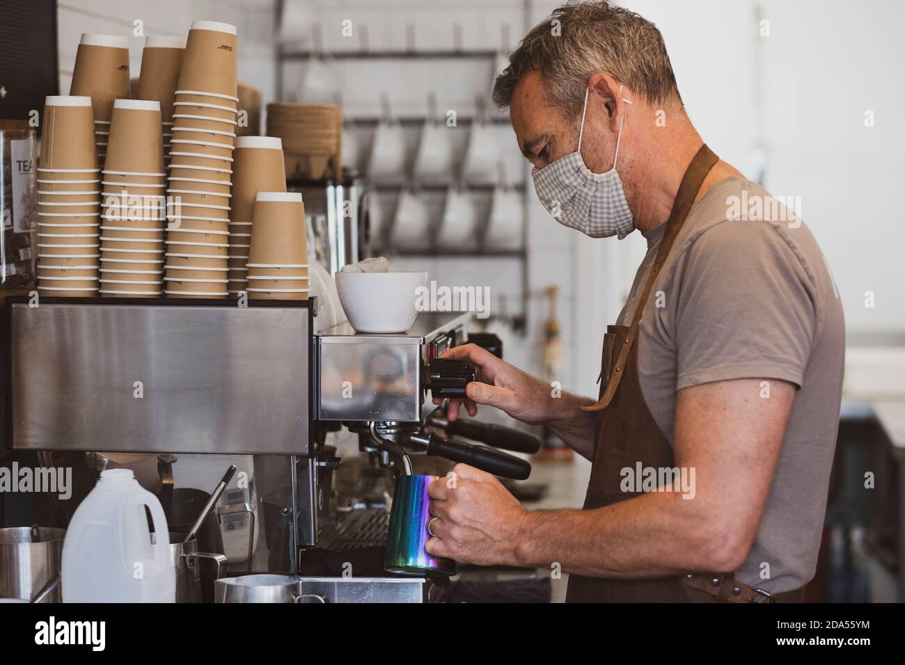 Male barista wearing brown hi-res stock photography and images - Alamy