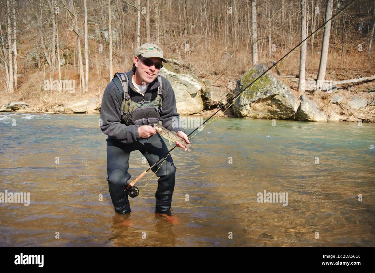 WINTER FLY FISHING HOLDING FRESH CAUGHT BROWN TROUT Stock Photo