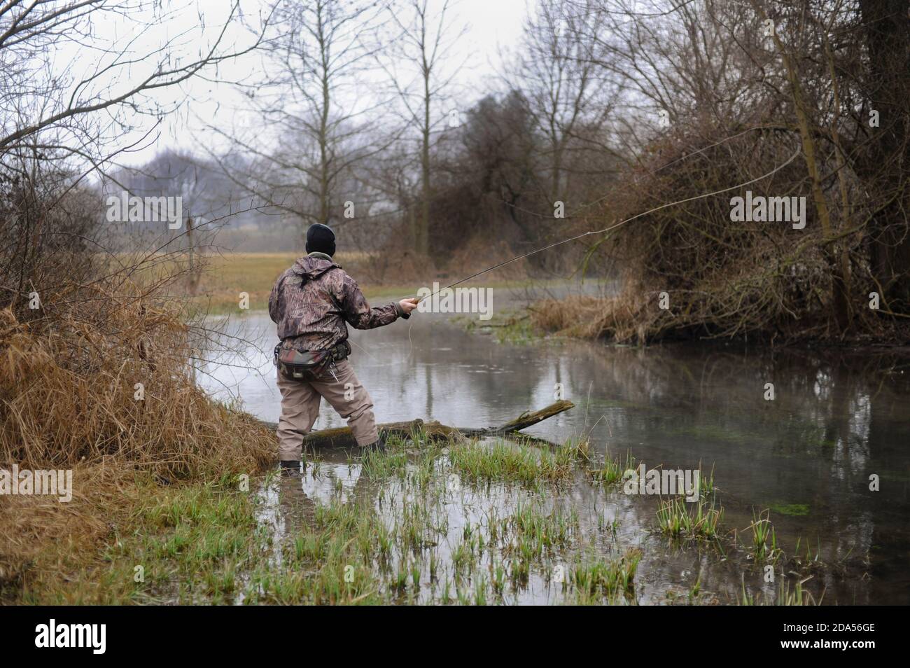 WINTER FLY FISHING CASTING FLY Stock Photo