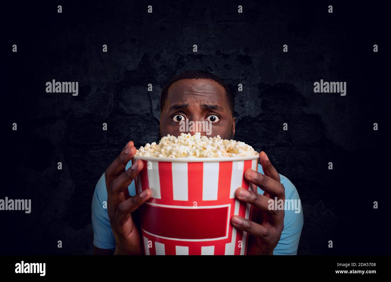 Worried boy watches a horror film. concept of entertainment and streaming tv. Stock Photo