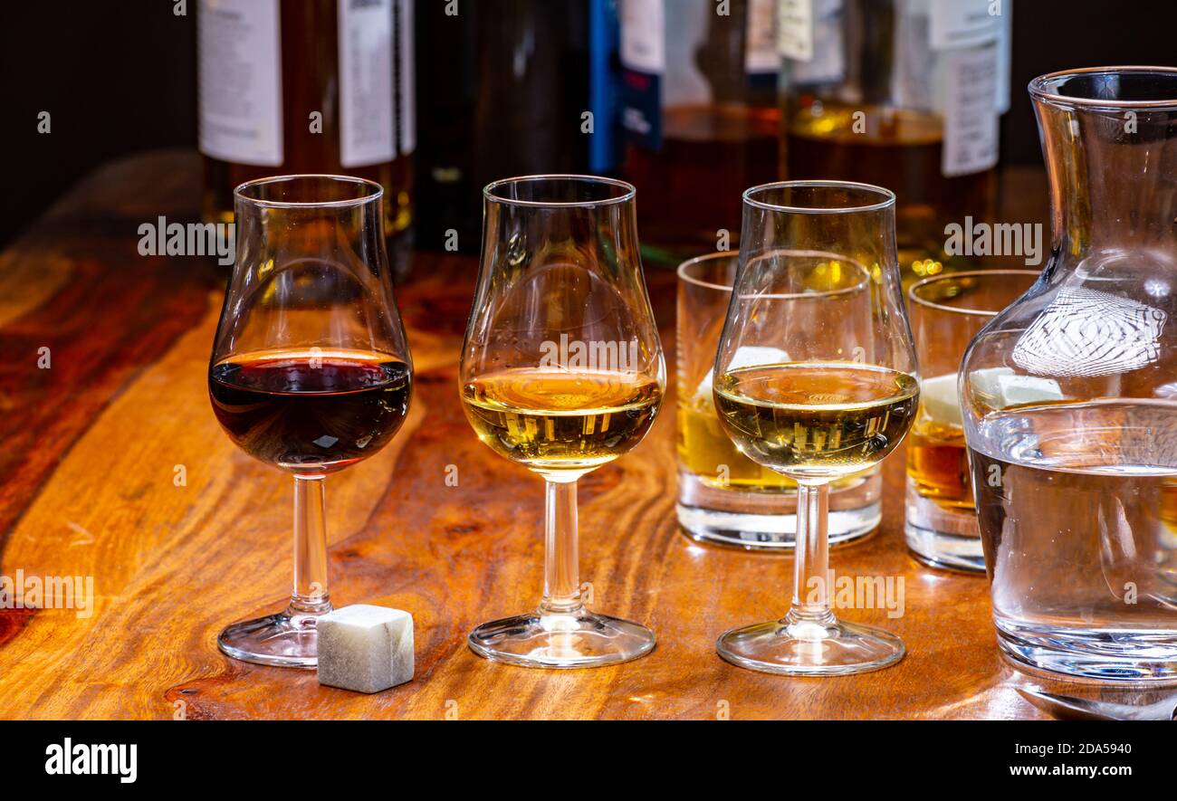 Tasting glass with strong alcoholic spirit drink whisky, cognac, armagnac  or calvados on wooden table Stock Photo - Alamy