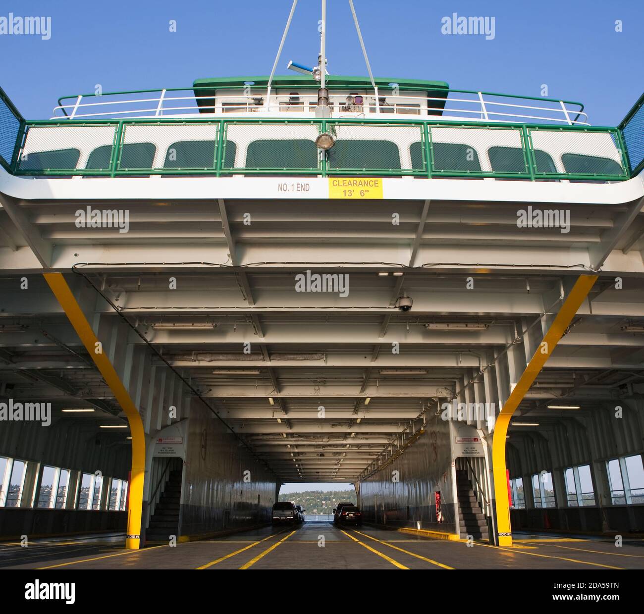 Car ferry on the water, car deck and upper deck, two cars and spaces