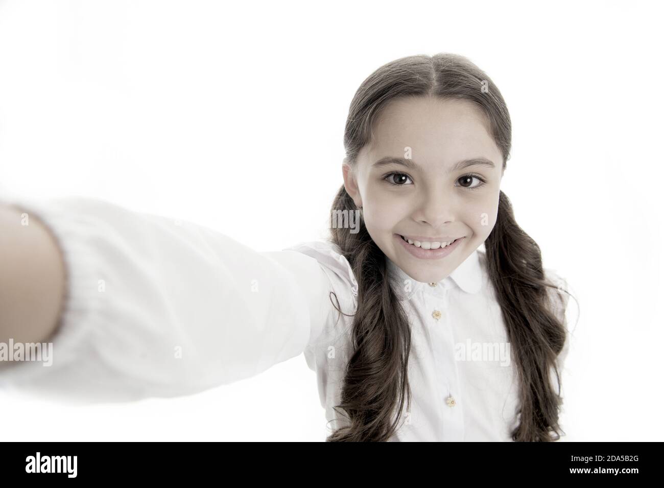 Let me take a selfie. Child girl school uniform clothes holds