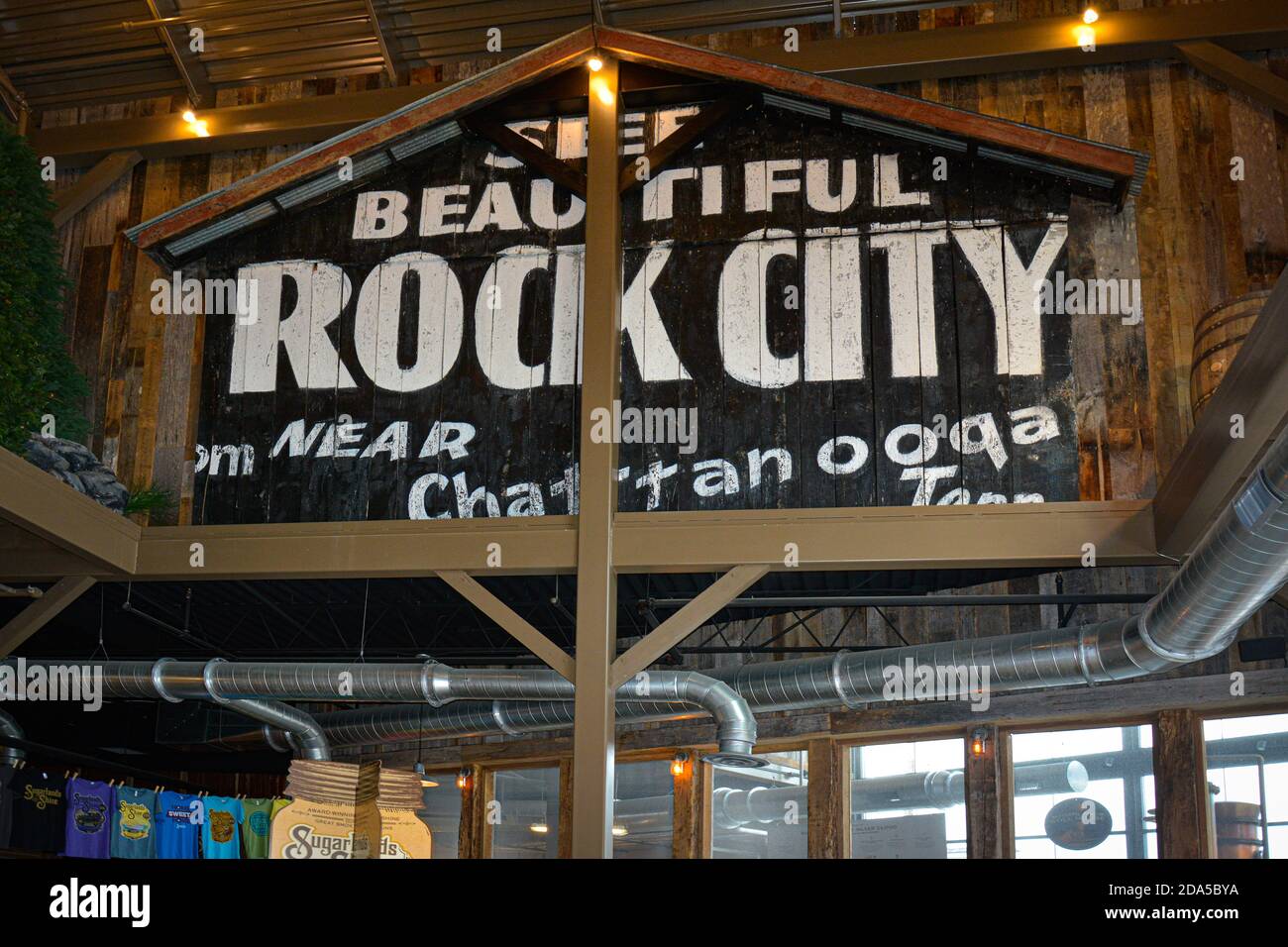 Inside the recycled local barn wood Sugarlands moonshine distillery, with a big 'See Rock City near Chattanooga, TN' painted wall in Gatlinburg, TN Stock Photo