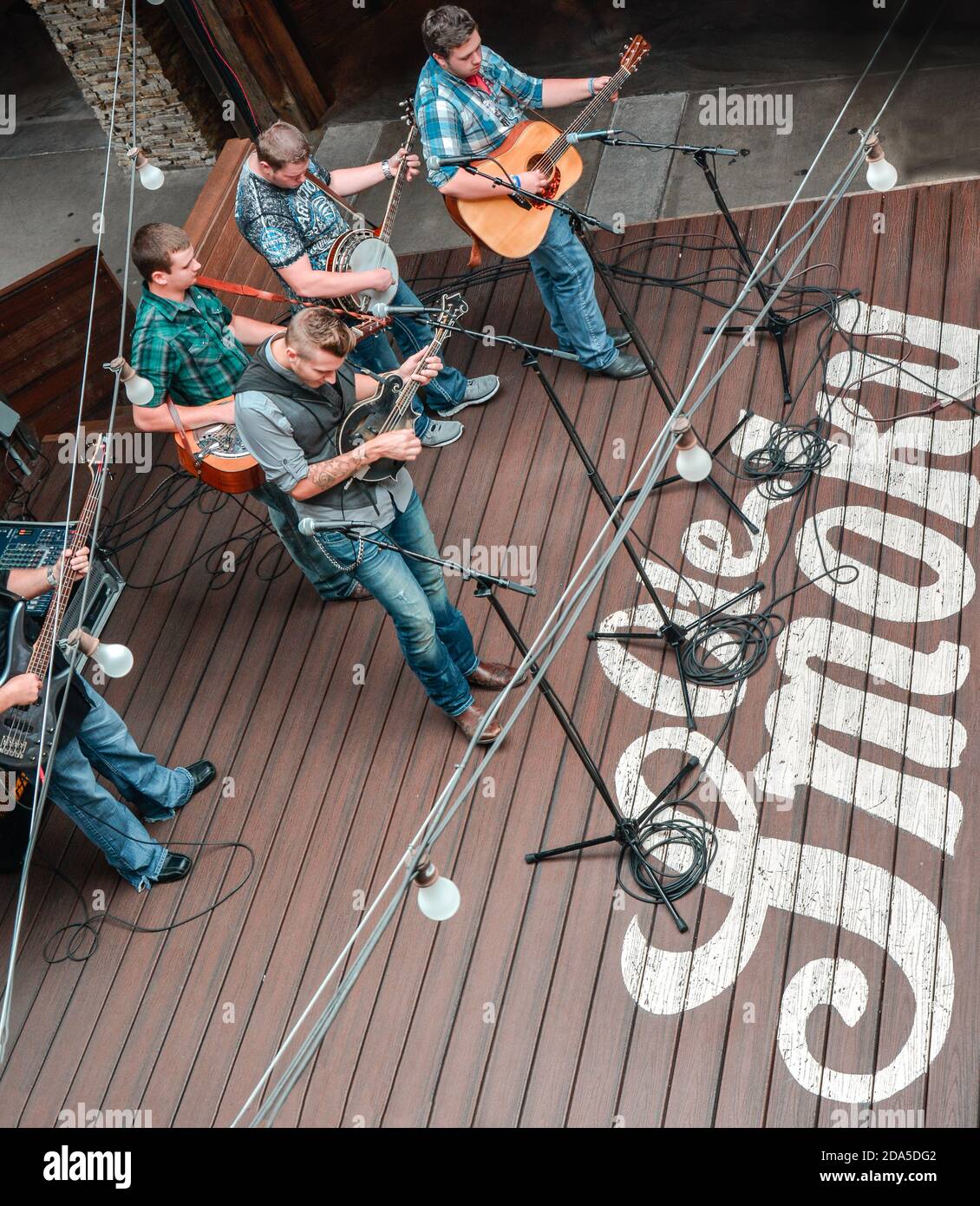 Overhead view of modern Blue grass band,  'Monroeville' playing a concert on stage at the Ole Smoky Moonshine Distillery, Gatlinburg, TN Stock Photo