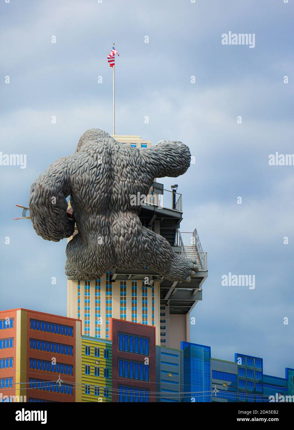 Surreal Rear view of replica of King Kong climbing a building while