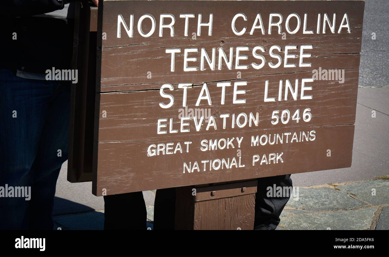 Close up of National Park wooden roadside sign marking the North Carolina and Tennessee State line in the Great Smoky Mountains at an elevation of 504 Stock Photo