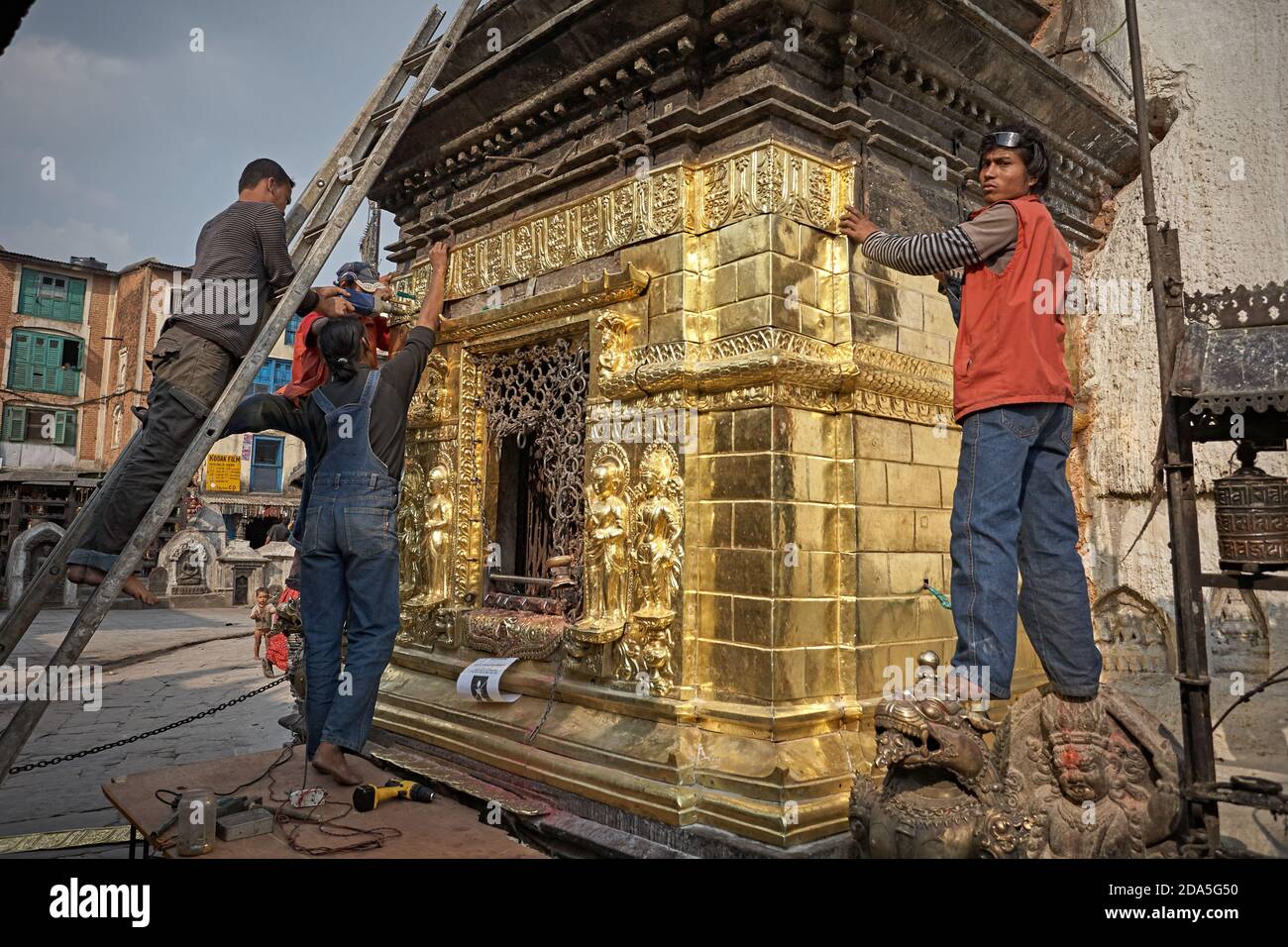 Kathmandu, Nepal, March 2009. Workers putting gold plates on the