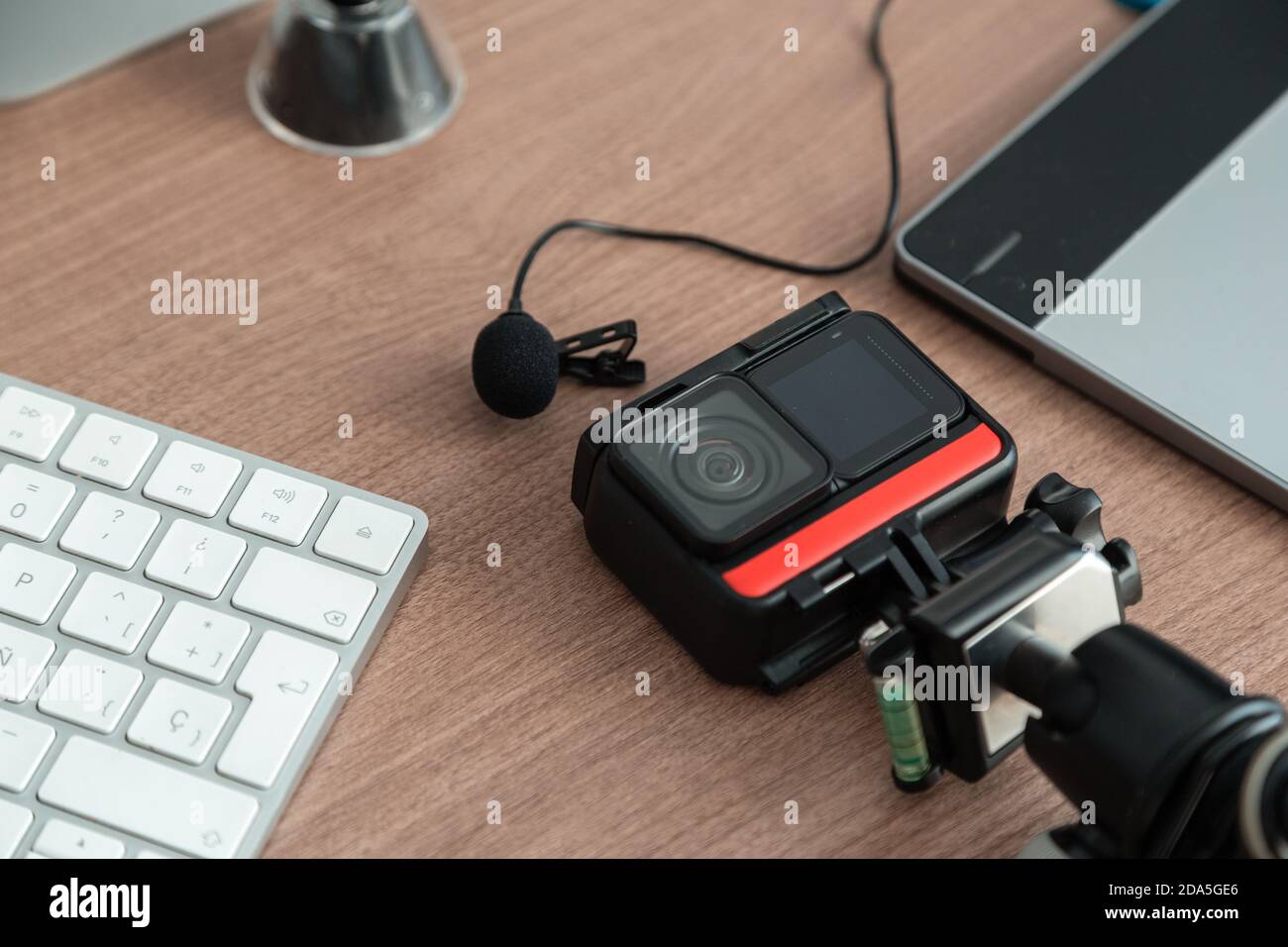 technological gadgets on the work desk, there is a camera, microphone, sd card, keyboard, technology and modern elements Stock Photo