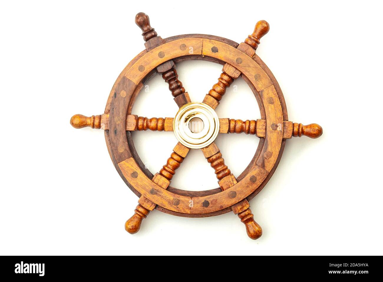 Navigation, nostalgia for bygone age of discovery and leadership conceptual idea with vintage ship steering wheel rudder made of wood and brass isolat Stock Photo