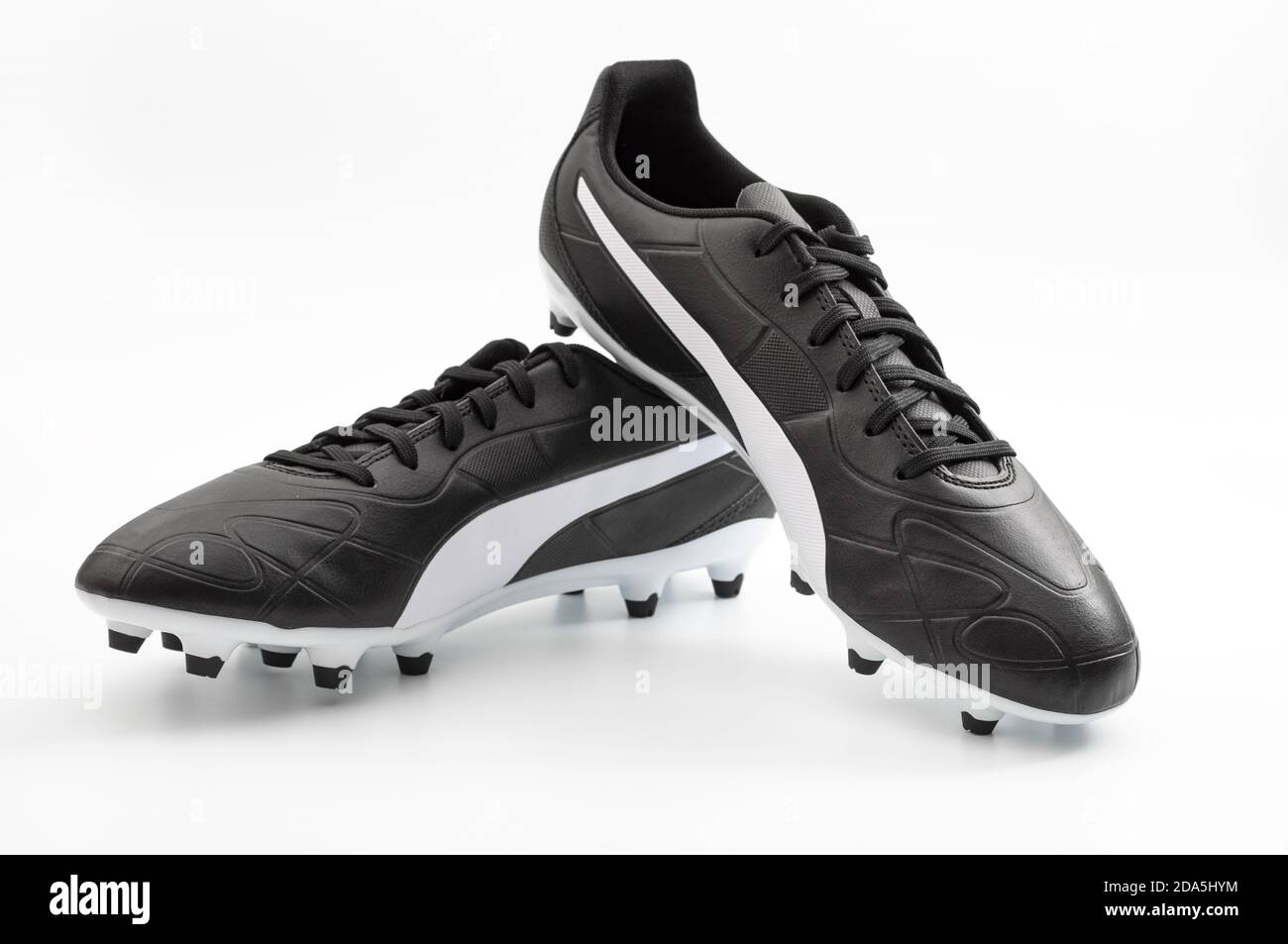 Athletic equipment and exercising footwear concept traditional leather soccer boots or football cleats shoes isolated on white with clipping path cuto Stock Photo