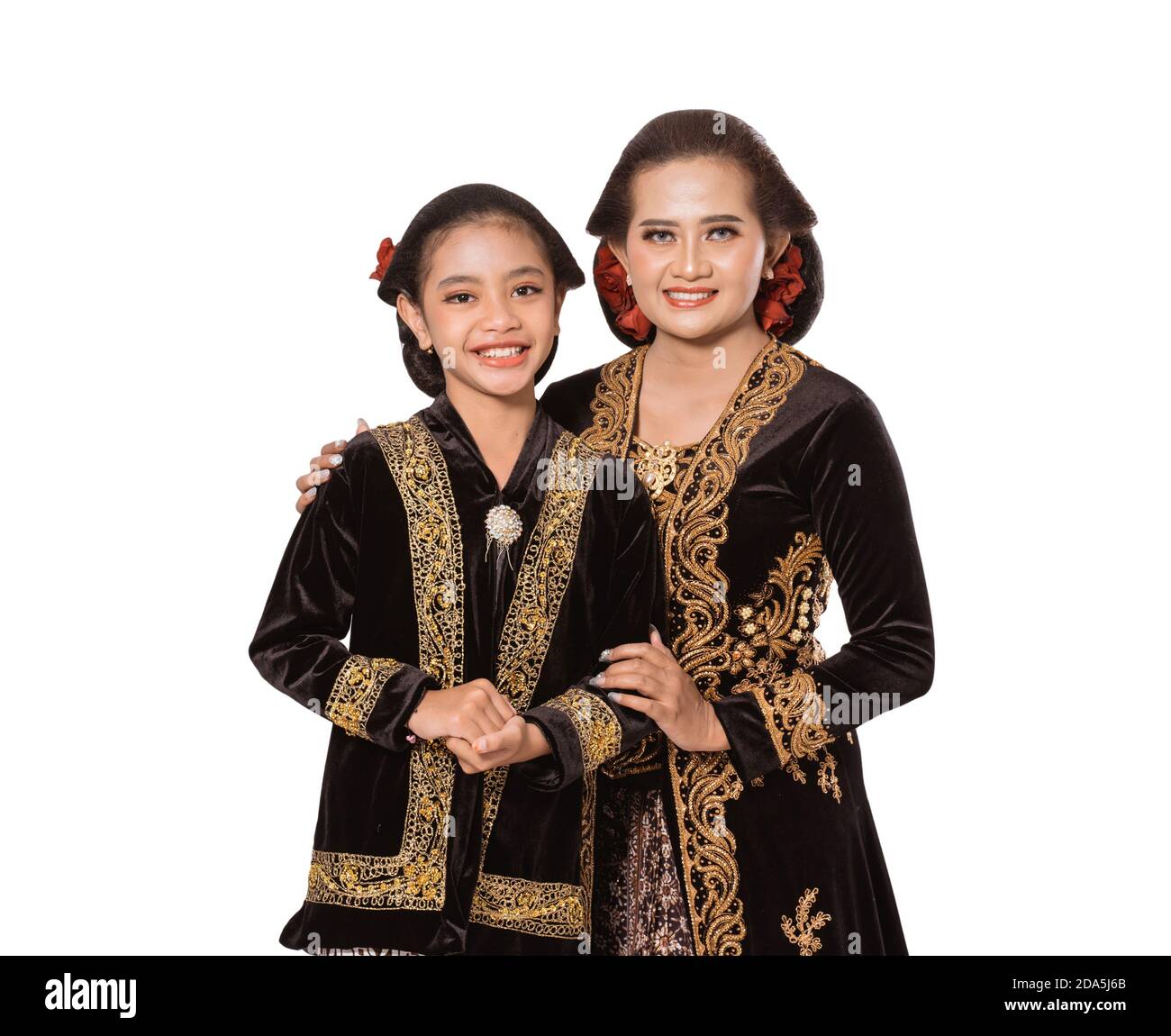 Javaanse Ouders Portrait of a happy mother holding her happy daughter with javanese ...