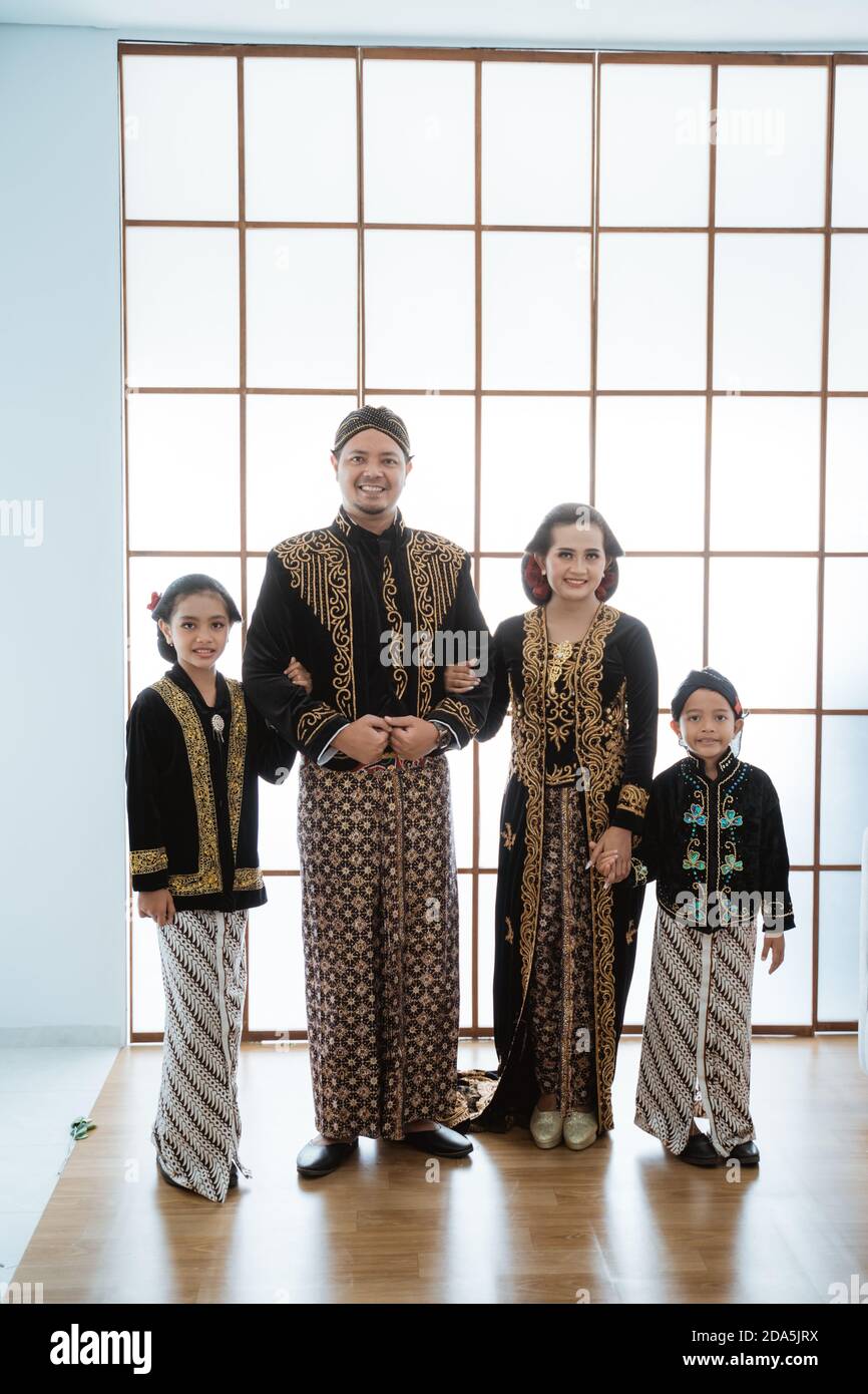 Portrait of a happy family wearing traditional Javanese clothes