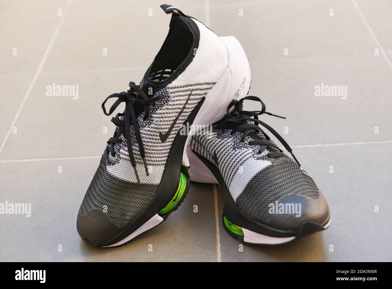 Nike running shoes, nike air zoom tempo next% white-black men's running  shoes on tile floor : Bangkok Thailand November 4, 2020 Stock Photo - Alamy