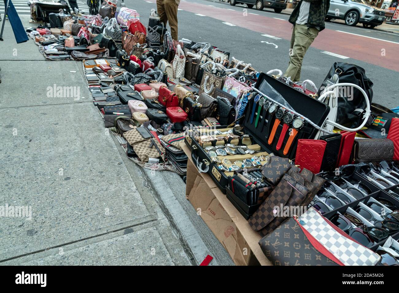 New York, NY - November 9, 2020: Street vendors sell counterfeits goods  like bags, sunglasses, belts and watches on Canal street and Broadway  corners Stock Photo - Alamy