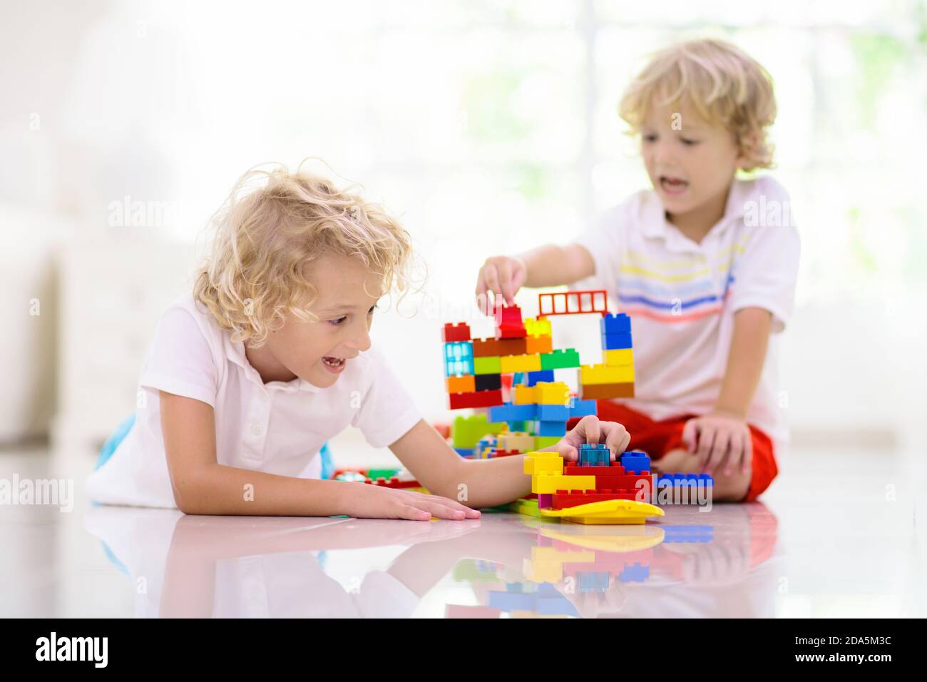 Child playing with colorful toy blocks. Kids play with plastic bricks ...