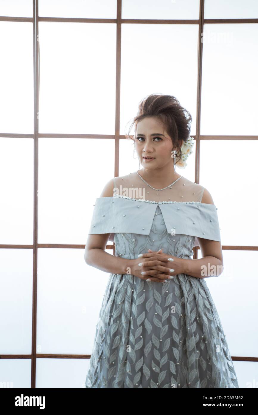 Portrait Of A Woman With Modern Dress Standing By The Window Stock 