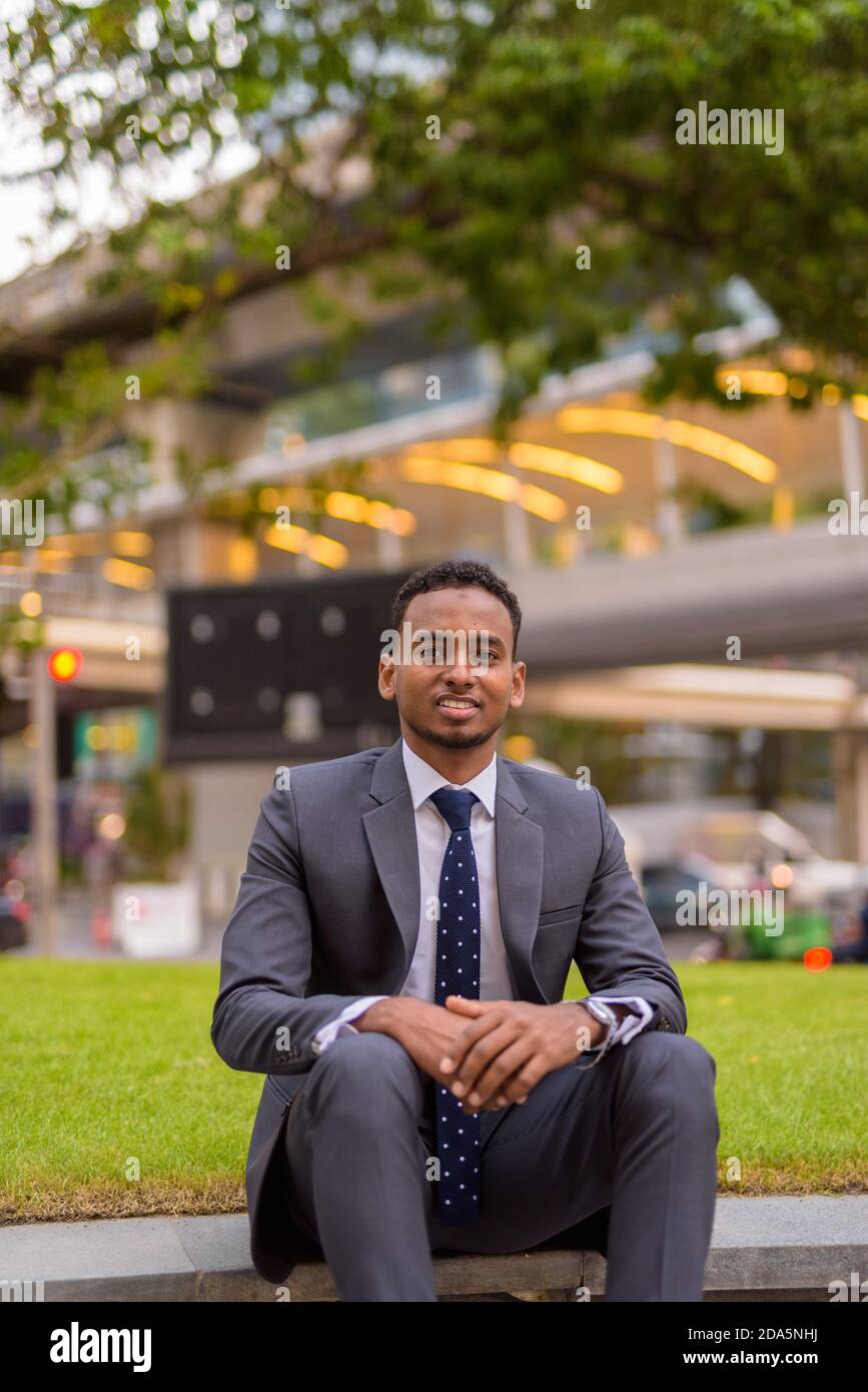 Black guy sitting hi-res stock photography and images - Alamy