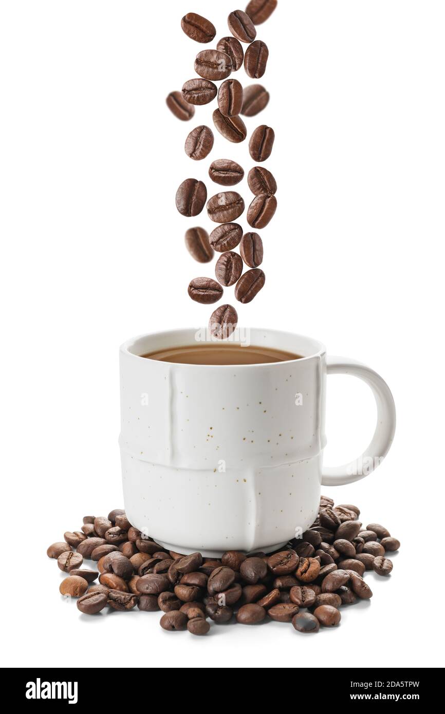 Cup of hot drink and falling roasted coffee beans on white background ...