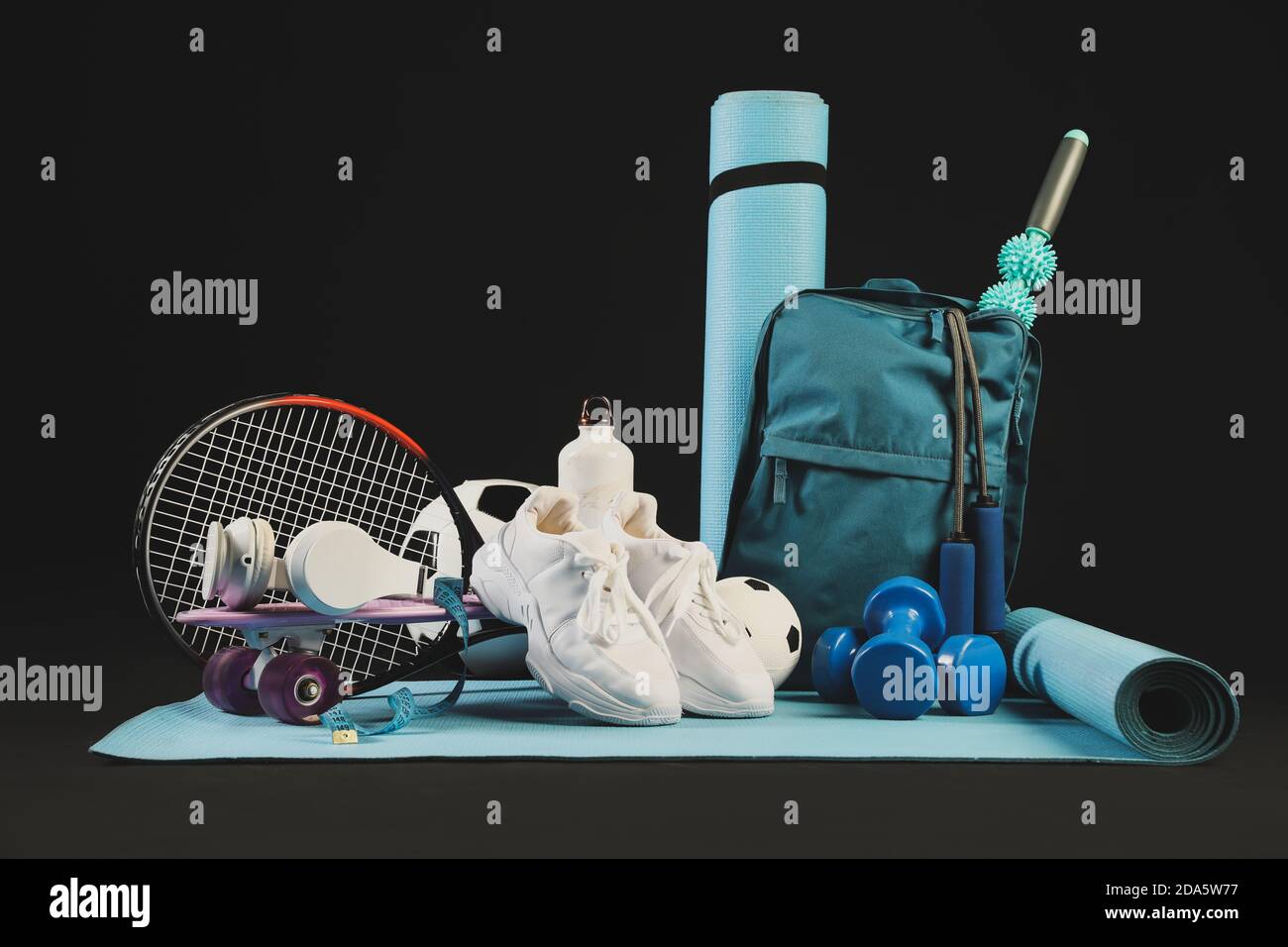 Set of sport equipment on dark background Stock Photo - Alamy