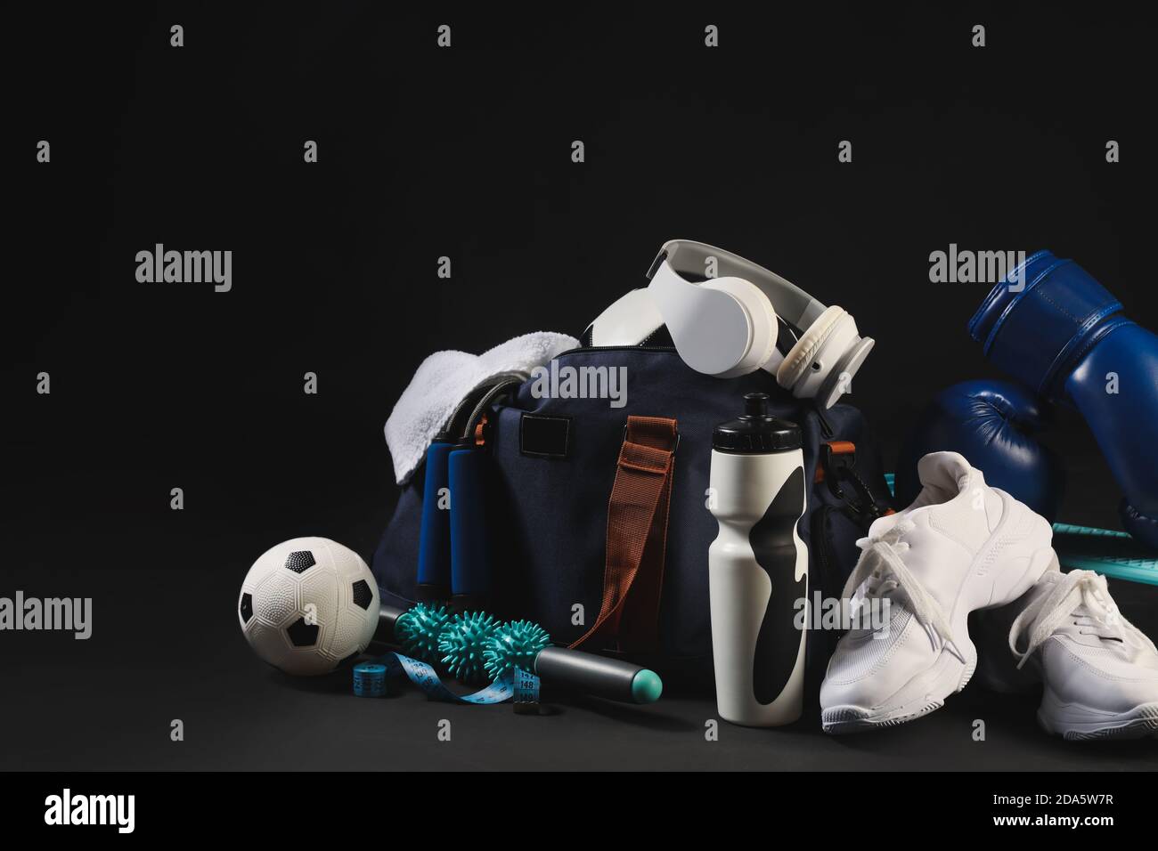 Set of sport equipment on dark background Stock Photo - Alamy