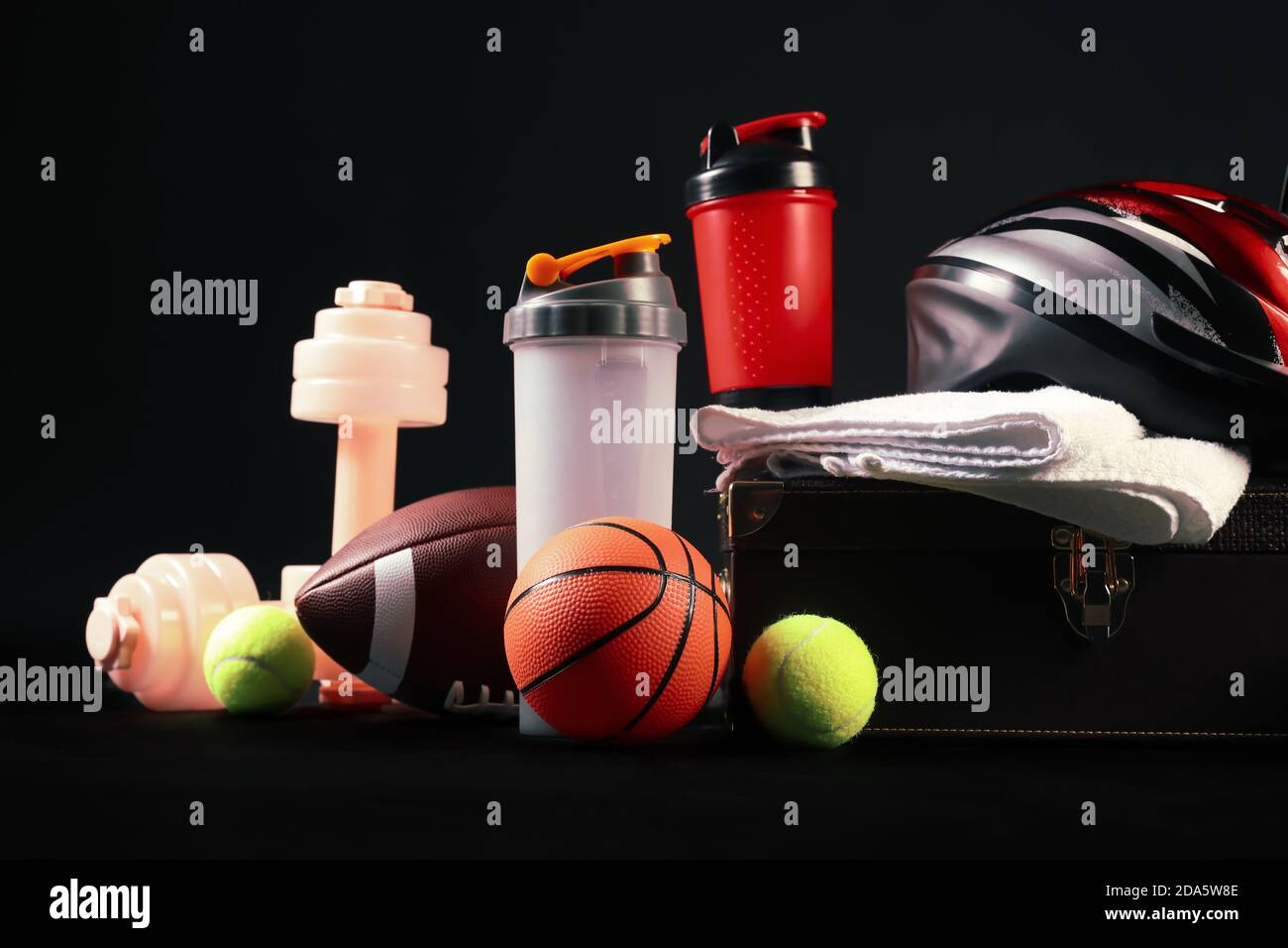 Set of sport equipment on dark background Stock Photo - Alamy