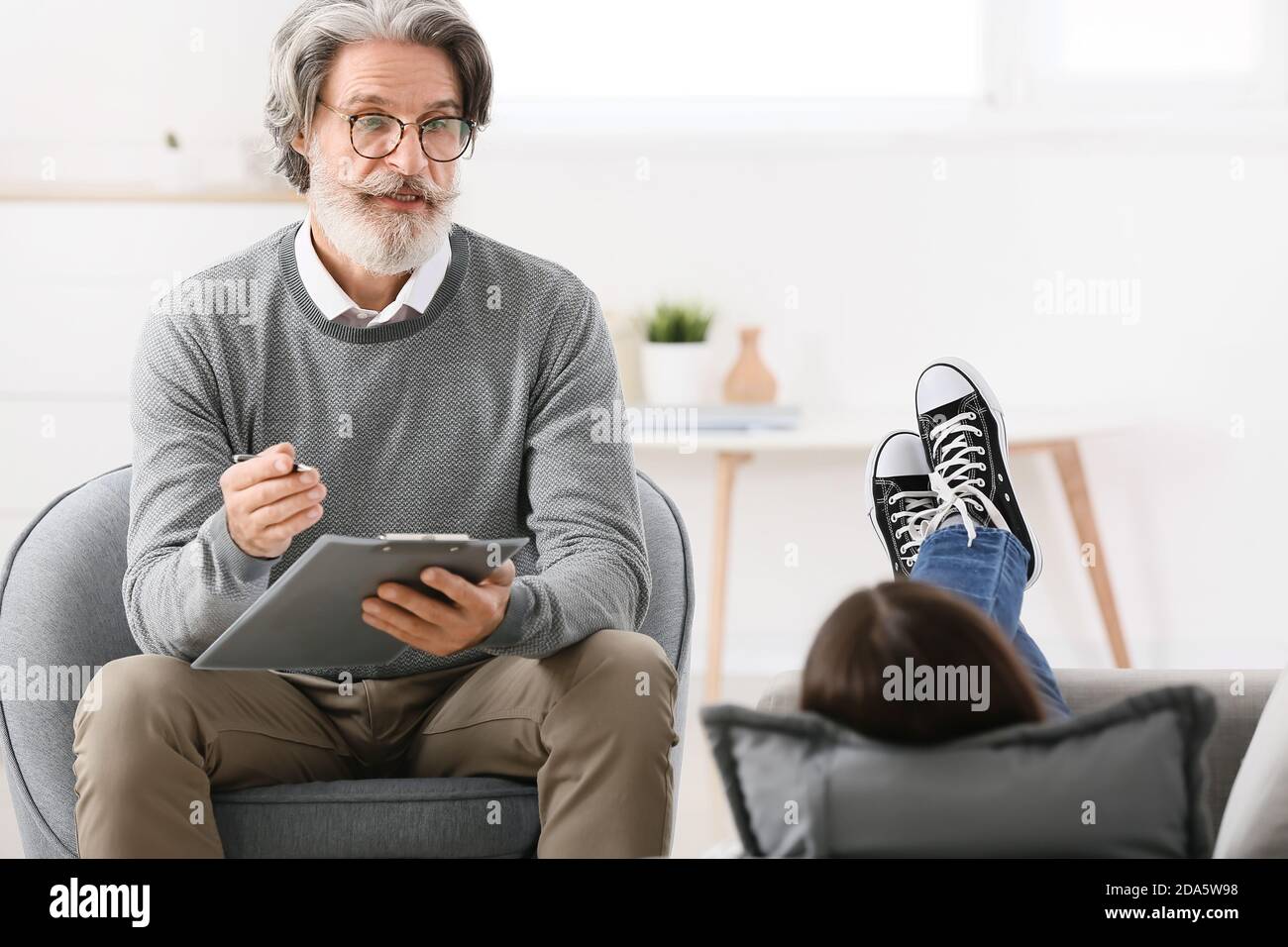 Male psychologist working with young girl in office Stock Photo Alamy