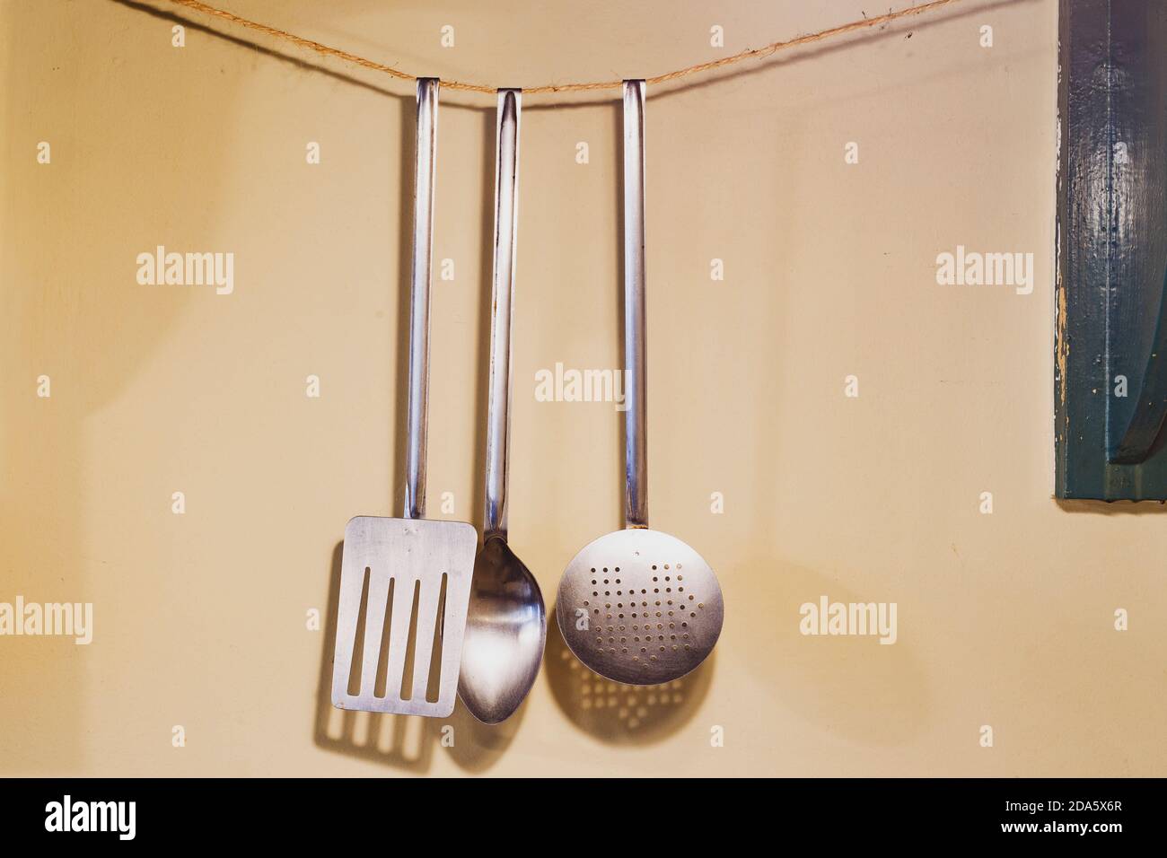 kitchen utensils hanging on wall Stock Photo Alamy