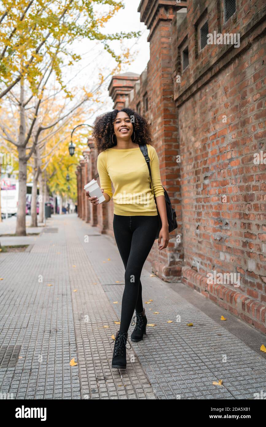 Afro-american woman walking on the street Stock Photo - Alamy