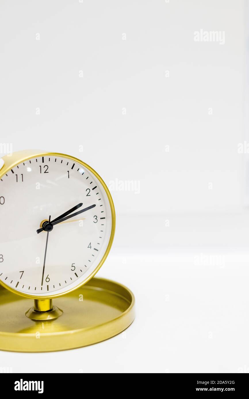 Old alarm clock with ten minutes past two date and time reminder or