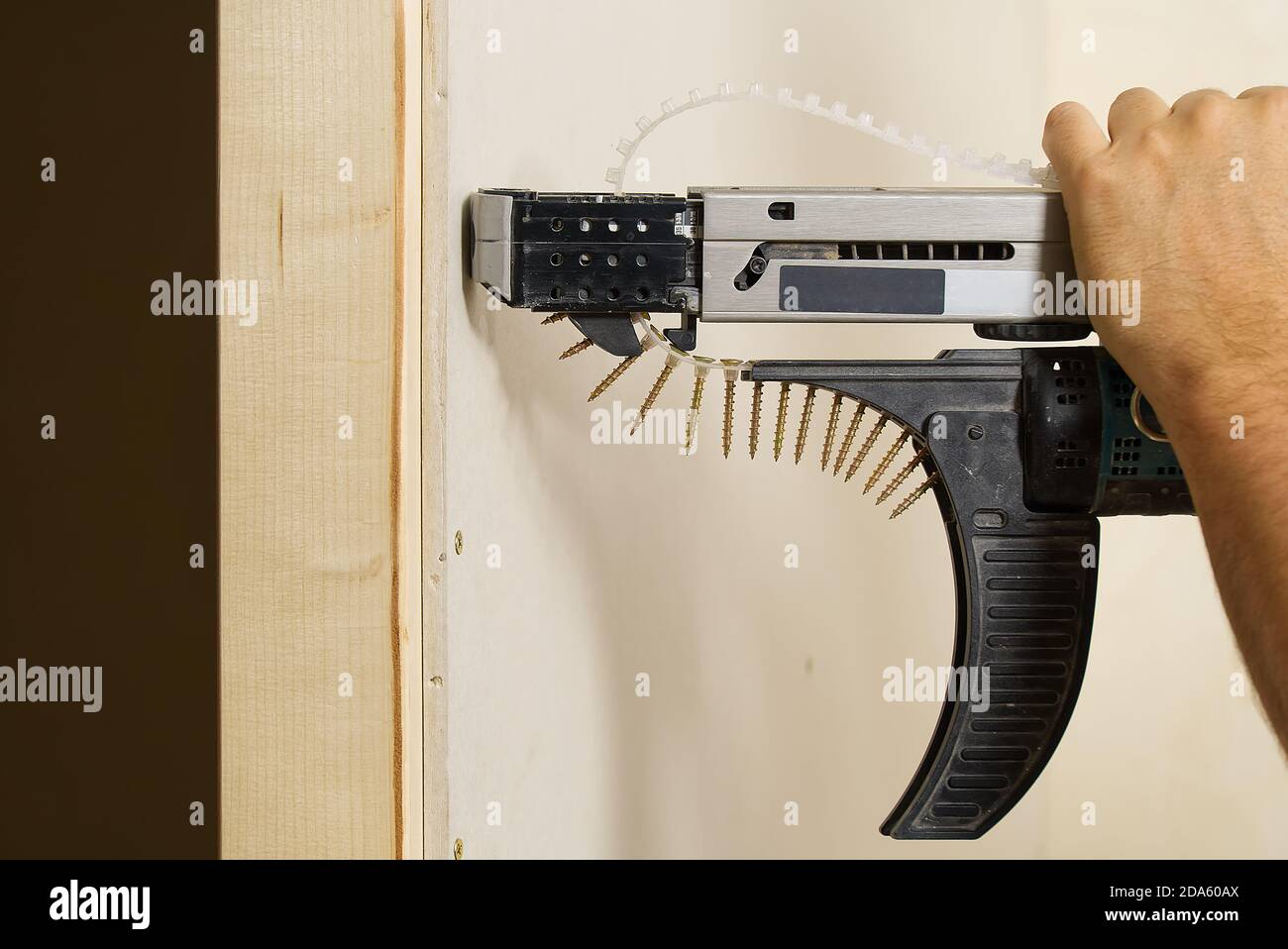 Room repair. Building. Worker fastens drywall with a screwdriver close