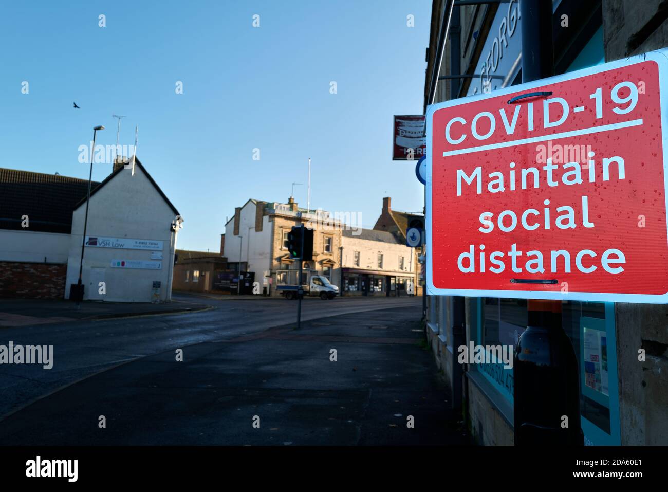 Notice on a post in the market town of Thrapston, Engand, about keeping social distance to stop the spread of coronavirus, October 2020. Stock Photo