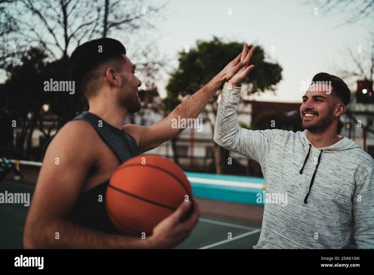 Two young friends playing basketball Stock Photo Alamy