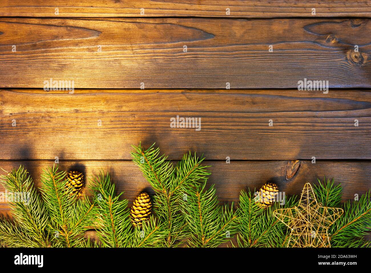 Christmas frame with fir branches, cones, on a dark wooden table. Top ...