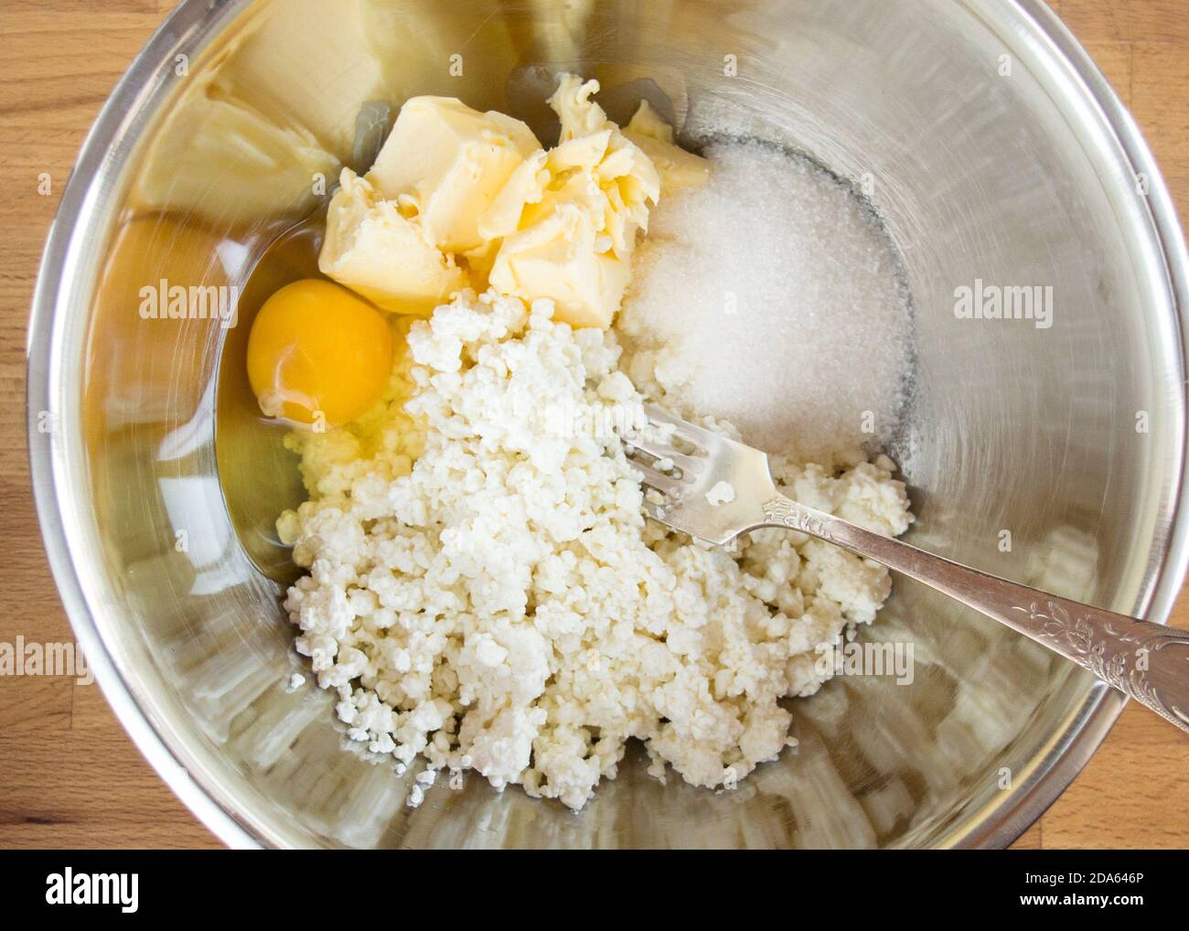 Raw ingredients in a bowl of curd biscuits. Top view, no people. Stock Photo