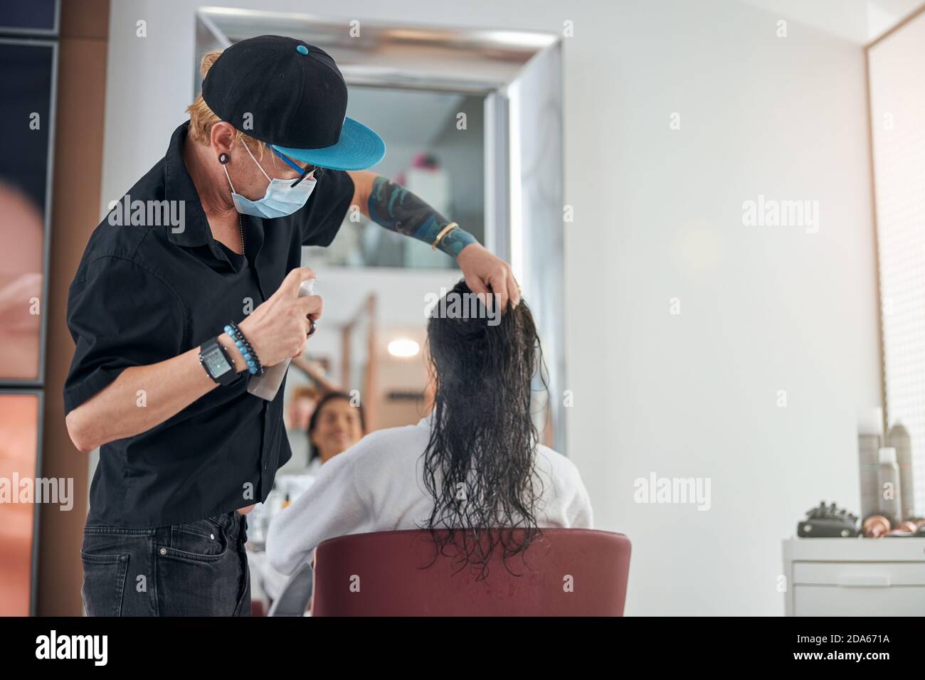Specialist lifting the hair making it prepared for next step Stock