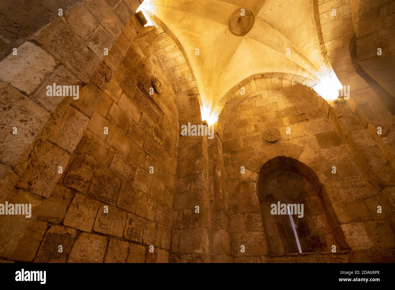 Jaffa Gate in the walls of the Old City of Jerusalem at night, looking out the window inside the gate Stock Photo